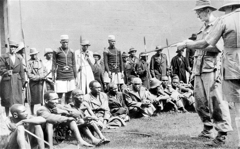 British soldiers guard Kenyan captives during the 1950s